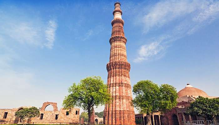 The scenic view of Qutub Minar against the backdrop of Delhi’s skyline.