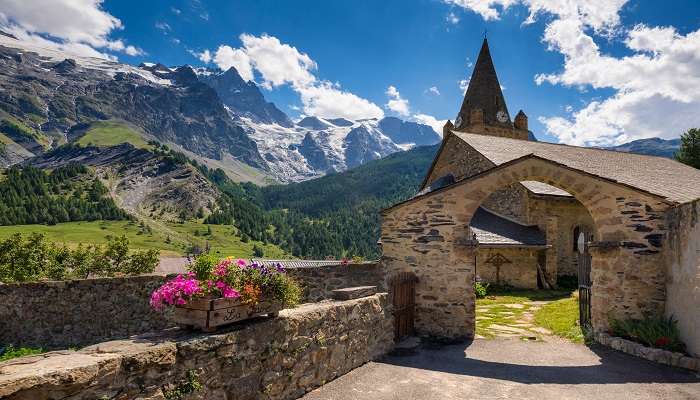 La Grave village and a church in the Ecrins National Park with La Meije mountain peak.