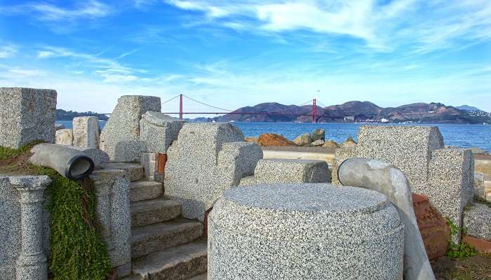 The scenic view of The Wave Organ with the Golden Gate Bridge in the background.