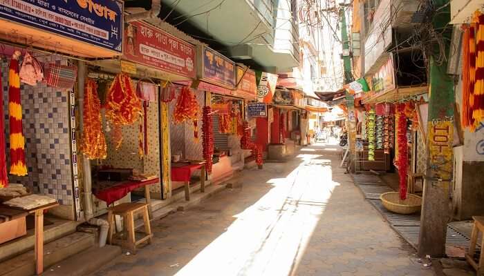 Vibrant stalls around the Tarapith Mandir offering essential pooja items for worshipping Tara Maa 