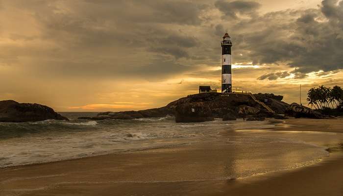 The Kapu lighthouse stands under a mesmerising evening sky with hues of orange and pink