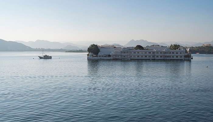 Overlooking Lake Pichola, the serene palace floating on the lake, defines the splendour of Udaipur on the Delhi to Udaipur road trip.