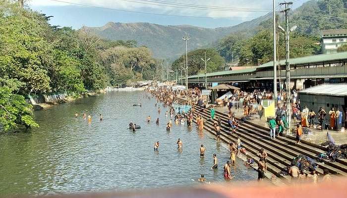 People taking a holy dip in the Pampa River