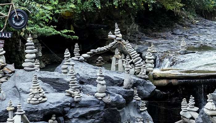Go hiking in various riverside trails while visiting Tegenungan Waterfall
