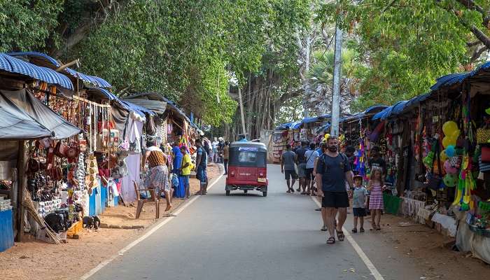 Shops alongside the road and people walking towards the Hindu Temple Koneswaram