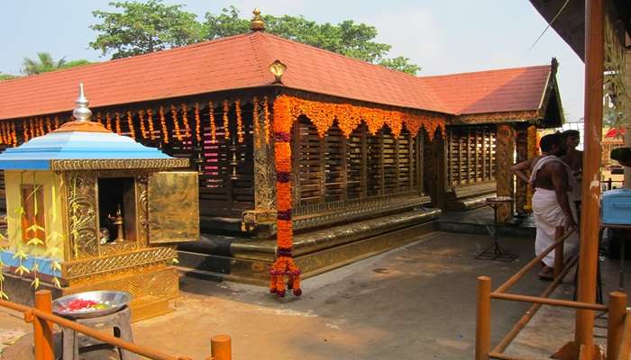 Devotee offering prayers at Aruvikkara Temple