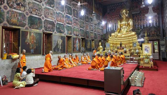 Monks performing rituals at Wat Paknam Phasi Charoen Temple.