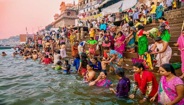 Devotees taking the holy bath in the Ganges near Kashi Vishwanath Temple.