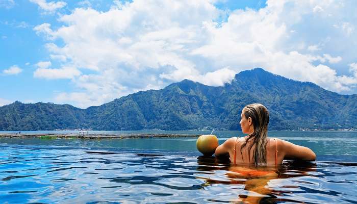A woman enjoying the infinity pool at Alam Anda Ocean Front Resorts 