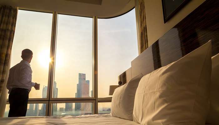 Enjoy the sunset with a favourite cup of drink in a luxury hotel room.