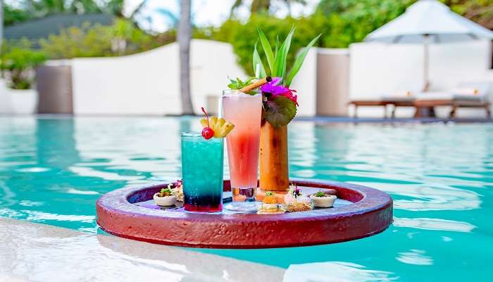 A floating tray having food in the swimming pool to enjoy to the fullest.