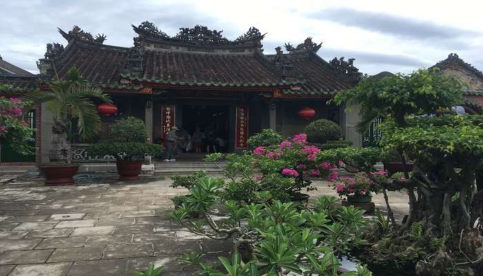 Fujian Assembly Hall in Hoi An covered with lush greenery.