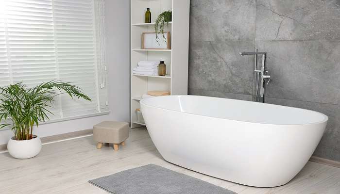 White clean, and well-maintained modern bathtub in a bathroom