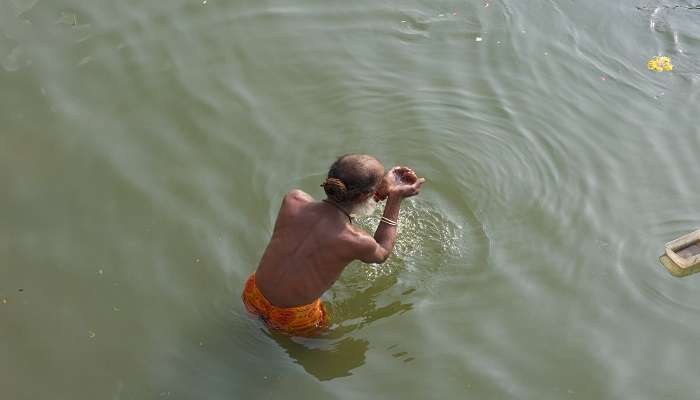 A man having holy bath at Potra Kund in mathura