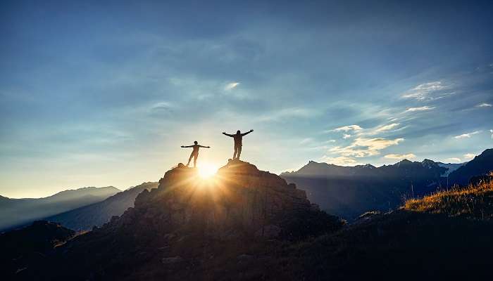 Hikers at the top of Pieter Both Mountain in Mauritius during sunset