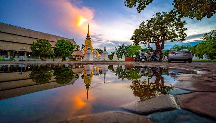 Twilight casts a serene glow on Wat Suan Dok Temple, a revered Buddhist site.