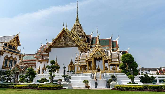 Discover the opulence of the Grand Palace in Bangkok in July when rain has washed the pinnacle to a gleam.