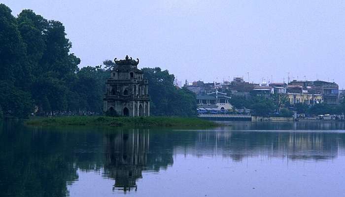 Hoan Kiem Lake, serene and vibrant, in Hanoi in July.