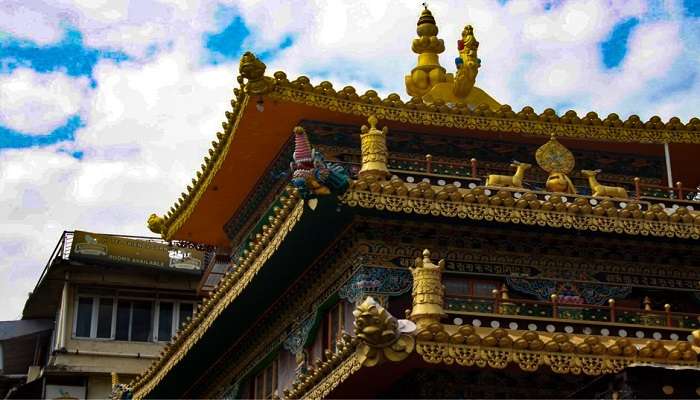 Tourists exploring The Dalai Lama Temple and admiring its surroundings