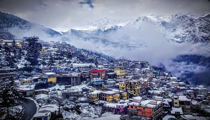 A serene view of Joshimath town after snowfall from a luxury hotela in Joshimath