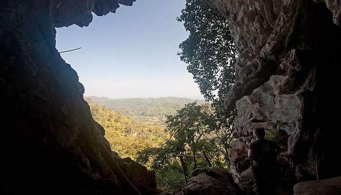 Entrance of Khlong Chak Cave amidst thick forest