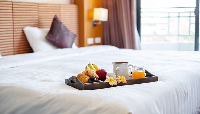 Breakfast tray on the bed at the top hotels in Nellore