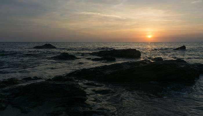 Bluish orange skies and the sun dipping down at Nui Beach