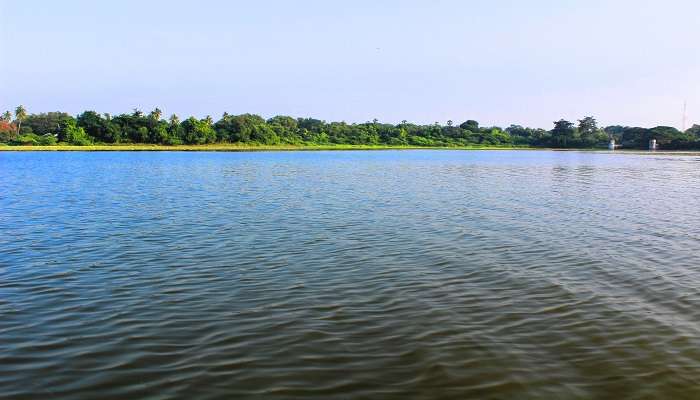 Ousteri Lake with lush greenery covering the sides