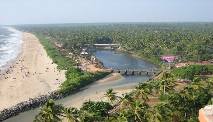 The Payyambalam beach Backwater with the beach water and golden sands