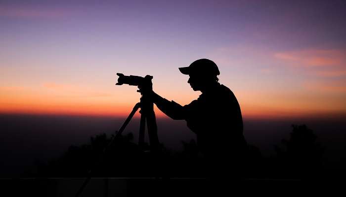 A silhouette of young photographer tourist at Samthar Fort 