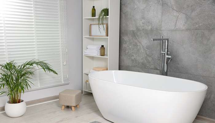 A white clean and modern bathtub in a hotel room