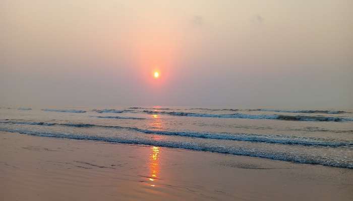 A view of the sun rising from the Manginapudi Beach
