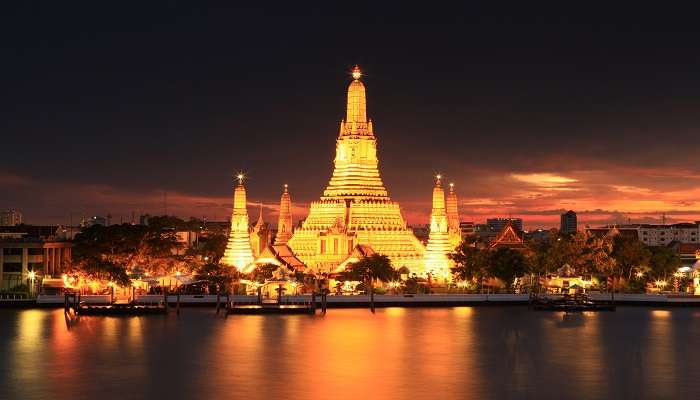 Ascend the steps of the temple, Wat Arun, in Bangkok in July where monsoon-lashed views are even more spectacular