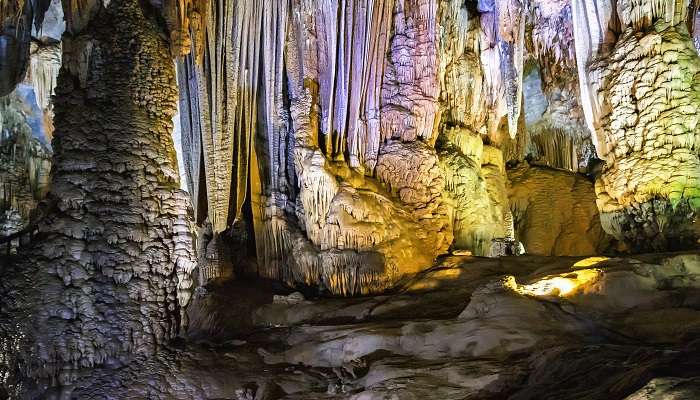 Stunning stalactite and stalagmite formations inside Thien Canh Son Cave. 