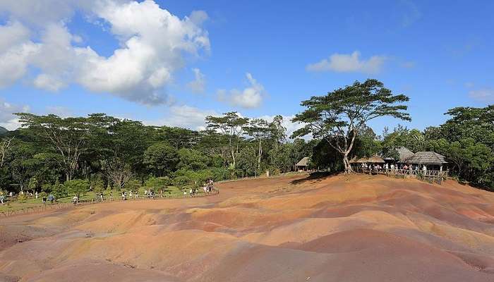 People are at the stunning seven-coloured earth of Chamarel.