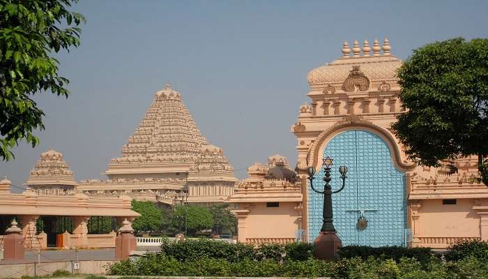 Visitors appreciate the excellent carving work done on the walls of this temple.