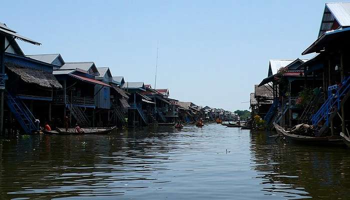Colourful boats behind the houses at Kampong Phluk Village