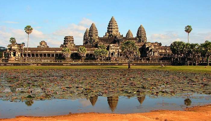 The stunning view of Angkor Wat, with its iconic spires reflected and water surroundings, one of the MGC Asian Traditional Textile Museum nearby attractions