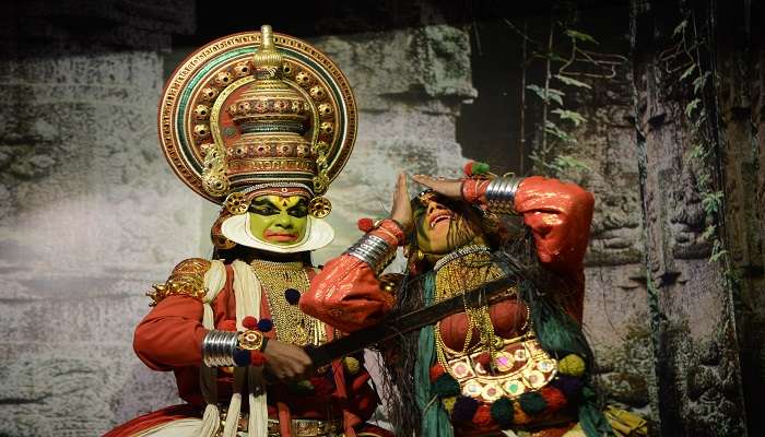 Vibrantly dressed Kathakali dancer performing