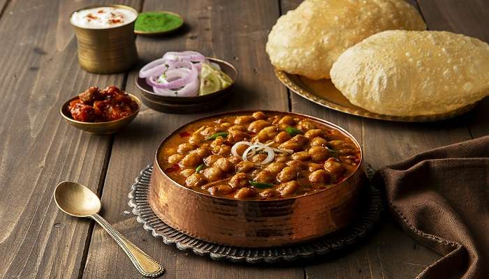 Crispy puris with spicy aloo sabzi and sweet halwa at Mohan Ji Puri Wale.