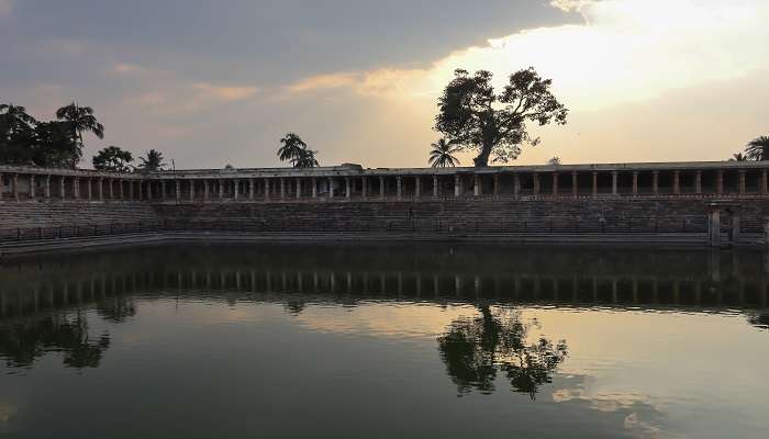 A Beautiful evening view of the Kalyani water collection pond against the sinking Sunlight and its reflections at Melukote Temple