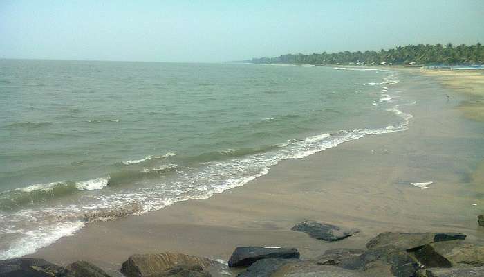 Walking along Beypore Beach, with gentle waves lapping at the shore
