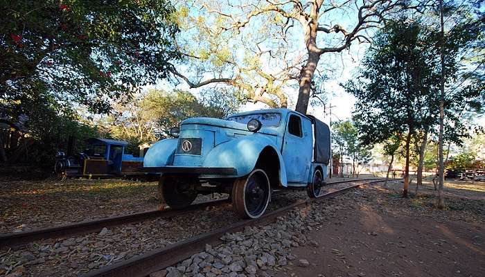 Blue vintage car on the railway tracks at Rail Museum Mysore