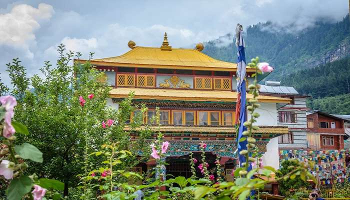 Beautiful pink flowers and green surround the Gompa Monastery