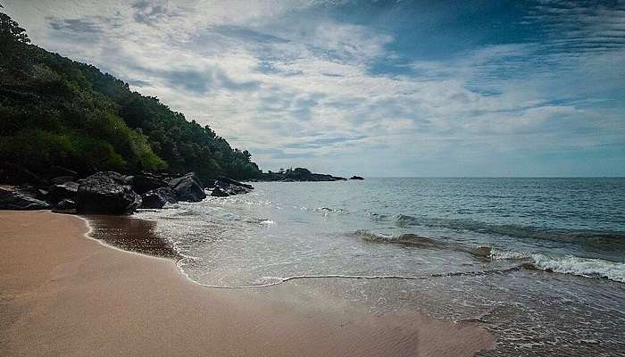 A serene view of the half-moon beach, one of the stunning places to visit in Gokarna in 1 day. 