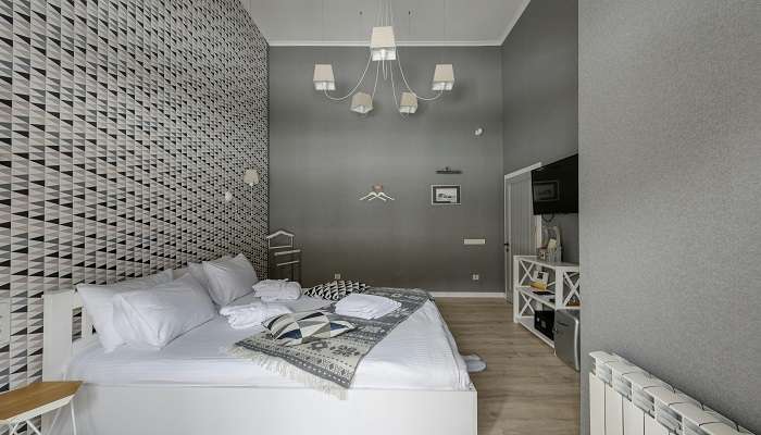A Gray and White Themed Hotel Bedroom