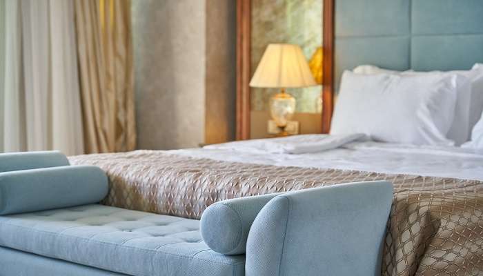 A cozy bedroom in hotels in Badami 