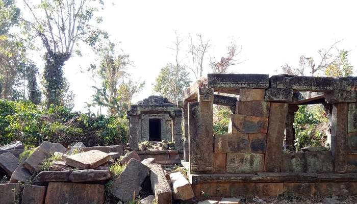 Ruins of the ancient Jain Temple at Ambukuthi Hills, showcasing intricate carvings