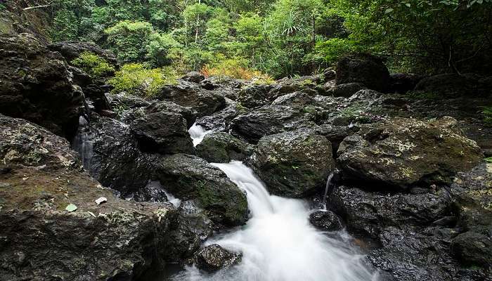 Jogigundi Falls flowing through rugged terrains