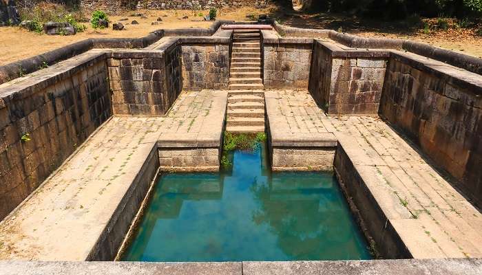 The old water bath at Kavaledurga Fort, Shimoga, Karnataka, India, is a top place to visit in Agumbe.